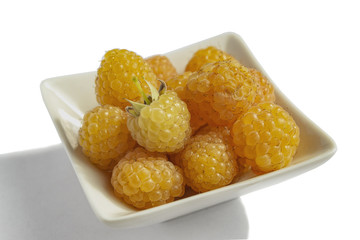 Yellow raspberry in a white Cup