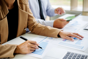 Business concept. Business people discussing the charts and graphs showing the results of their successful teamwork.