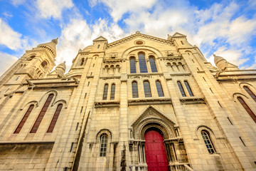 Fototapeta na wymiar Left side facade and door of Basilique Sacred Heart in Montmartre of Paris in France with no people. Popular religious attraction in Paris city of France, Europe.