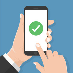 Flat design style human hand  holding smartphone or tablet with green check mark on the screen , vector design element illustration