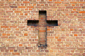 cross on a brick wall
