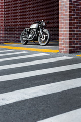 Caferacer motorcyle parking near brick wall of industrial building. Everything is ready for having fun after hard day in office. Businessman city hipster hobby. Space for your individual text. - 214188913