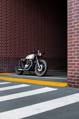 Vintage motorbike parking near brick wall of finance building. Everything is ready for having fun...