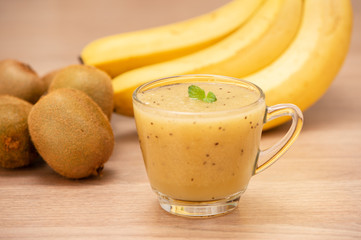 Tropical fresh fruit set and juice smoothies isolated with wooden background