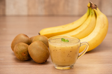 Tropical fresh fruit set and juice smoothies isolated with wooden background