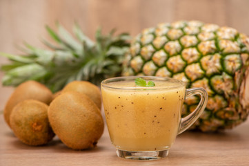 Tropical fresh fruit set and juice smoothies isolated with wooden background