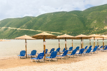 Fototapeta na wymiar Umbrella and chairs on the beautiful beach and sea - Vacation concept