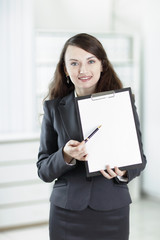 modern business woman pointing at blank sheet.