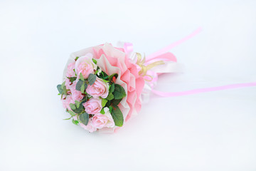 Artificial pink roses bouquet isolated on white background.