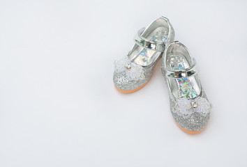 Pair of fashion princess baby shoes on white background with copy space.