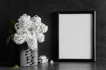 Fresh bouquet of white lilac flowers in the black vase on dark background. Condolence card. Empty place for emotional, sentimental text or quote. Photo frame.