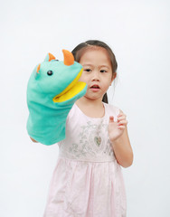 Adorable little Asian child girl hand wear and playing Rhinoceros puppets on white background.