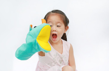 Adorable little Asian child girl hand wear and playing Rhinoceros puppets on white background.
