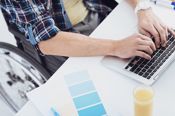 Modern technology. Disabled man sitting on wheelchair and having freelance work