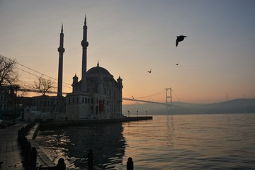 Naklejka premium Sunrise in Istanbul by Ortakoy Mosque and Bosphorus Bridge