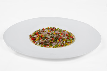 Meat cut with vegetables and gravy.