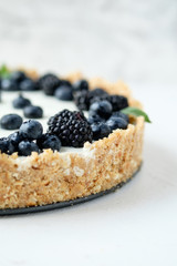 Cheesecake with blueberries and blackberries close-up