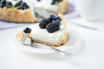 Piece of cheesecake with blueberries and blackberries