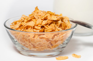corn flakes in a glass bowl on a white background