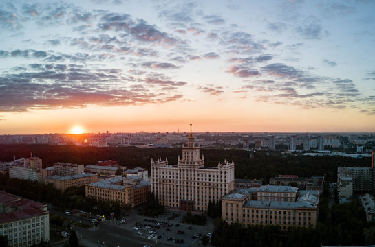 Aerial drone panoramic view of university campus in the city center of Chelyabinsk, huge city park with coniferous forest, recreation zone in polluted city, sunny evening in South Ural capital, Russia