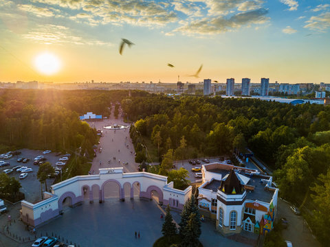 Aerial drone panoramic view of entrance group of one of the most huge city park in Russia, recreation zone in polluted city, sunny evening in the South Ural capital