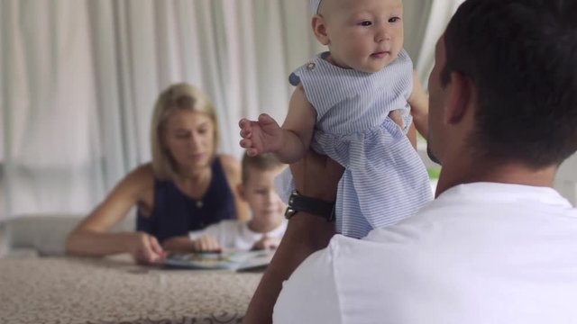 Father nursing with baby daughter in cafe