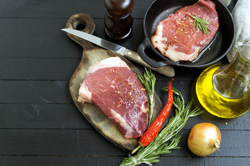Fototapeta na wymiar Raw meat. Raw beef steak on cutting Board and spices.