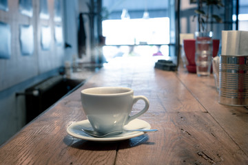 White cup of coffee at the cafe interior