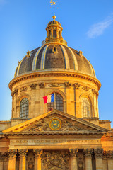Fototapeta na wymiar Details of central dome roof of Institut de France building, a French learned society group of five academies in Paris, France, Europe. Sunny day in the blue sky. Vertical shot.