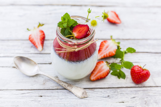 Healthy and delicious strawberry smoothie with grains and fresh fruits in jar. 