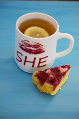 Cheesecake with raspberries and black tea with lemon close-up. Light breakfast.