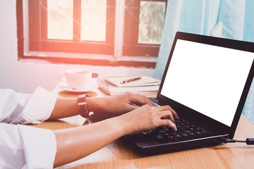 Naklejka premium Business man sitting using laptop with blank screen on desk in office at home