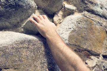 climber, a man's hand on a rock
