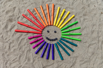 Boomwhackers in form of a smile in the sand