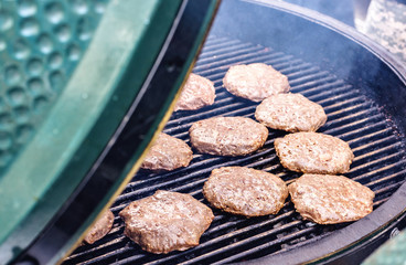 Patties cooking on grill cooker