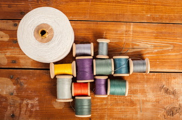 Sewing on the background of the old wooden walls