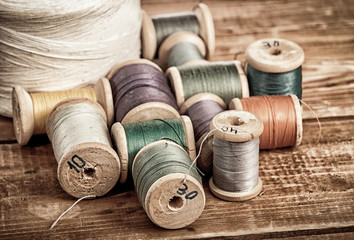 Sewing on the background of the old wooden walls
