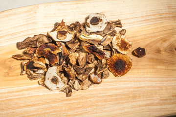Dried porcini mushroom over wooden background