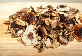 Dried porcini mushroom over wooden background