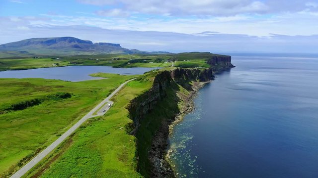Flight over the green coastline and cliffs on the Isle of Skye in Scotland