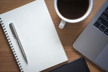 business documents on office table with smart phone and digital tablet and graph financial with social network diagram and computer laptop on wood desk