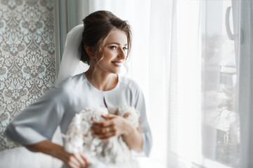 Obraz na płótnie Canvas Morning preparations. Gorgeous bride in white luxury dress is getting ready for wedding.