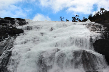 Nyastolfossen falls, the second in cascade of four waterfalls in Husedalen valley, Kinsarvik, Norway