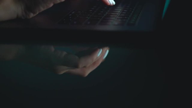 Hands or woman office worker typing on the keyboard at night
