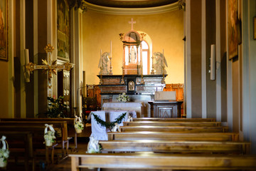 Fototapeta na wymiar Tornavento, Lombardy, Italy, church interior with decorations for wedding ceremony