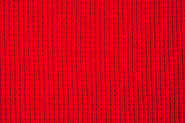 Textured fabric of red color shot close-up