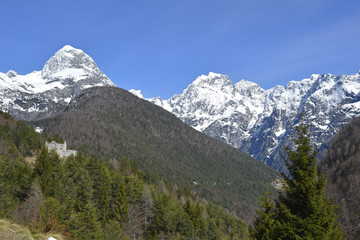 Fototapeta na wymiar The Slovenian Alps in April, including Mangart on the left. Viewed from Lake Predil or Lago del Predil in Friuli, Italy 