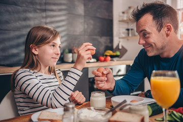 Father and daughter having breakfast