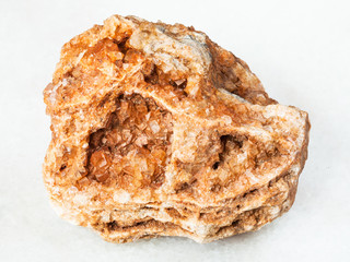 Wulfenite crystals on rough rock on white