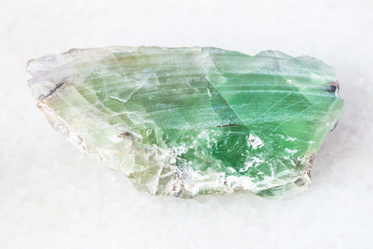 slab from green Beryl gemstone on white